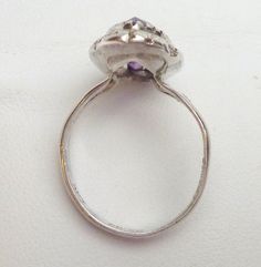 This is a really pretty ring that was so hard to photograph! Please know - the stone is not as bright purple as the photos show. Due to the color change optics of the stone, the camera can only show one color. The stone is actually a deeper purple with flashes of teal, and the stone will become more teal in different types of light. This ring features a marquise cut synthetic alexandrite that measures 15 x 7 mm. The stone is set in a bezel that is cut to look like lots of tiny prongs. The area a Vintage Birthstone Ring With Bezel Setting, Vintage Oval Amethyst Wedding Ring, Vintage Oval Amethyst Ring For Wedding, Vintage Bezel Set Promise Ring, Vintage Promise Ring With Bezel Setting, Vintage Purple Amethyst Ring For Anniversary, Vintage Amethyst Crystal Ring With Gemstone Detail, Vintage Amethyst Crystal Ring With Gemstone, Vintage Crystal Ring With Cabochon