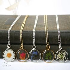 "Our Large Round Pendant is minimal and classic. Available in 24k gold plated or .999 sterling silver plated and in a variety of real preserved botanicals.  Choose from 24k gold plated or .999 sterling silver plated. The Dandelion Seed symbolizes wishes. The Fern is a symbol of sincerity Daisy is a symbol of hope.  Forget-me-nots are known as a symbol of lasting friendship, love, and remembrance   Thyme is a symbol of courage. Pendant hangs from a gold or silver plated chain, available in 26\" o Nature-inspired Flower Charm Round Pendant Necklace, Gold Jewelry With Flower Charm Keepsake, Nature-inspired Round Birth Flower Necklaces, Yellow Gold Flower Pendant Necklace For Keepsake, Nature-inspired Round Birth Flower Necklace, Round Nature-inspired Birth Flower Necklace, Minimalist Birth Flower Jewelry Keepsake, Gold Charm Necklaces With Birth Flower For Keepsake, Dainty Flower Pendant Jewelry Keepsake