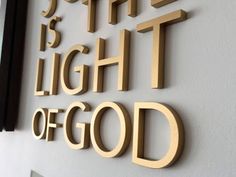 there is a sign that says, the light of god on the side of a building