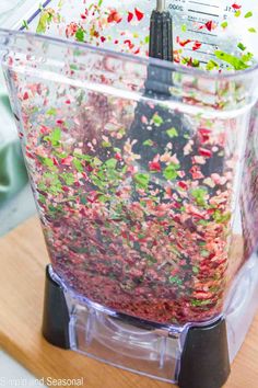 a blender filled with lots of different colored liquids and sprinkles