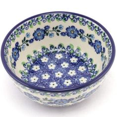 a blue and white bowl with flowers on it