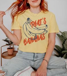 Go bananas for vintage style with our "That's Bananas" retro inspired graphic tee. We use professional quality DGT printing on all our apparel. Direct-to-garment, or DTG, is a high quality printing method that sprays ink directly onto the garment so there is no peeling or cracking. This fabulous graphic will be printed on a Comfort Colors Unisex T-Shirt. Please refer to the size charts in the images for the best fit.  Estimated Production Time: 1-5 days Estimated Shipping Time: 2-5 days 100% cot Vintage Aesthetic Retro, Banana Shirt, Fruit Puns, Food Pun, Funny Fruit, Aesthetic Retro, Retro Graphic Tees, Vintage Aesthetic, Summer Tshirts