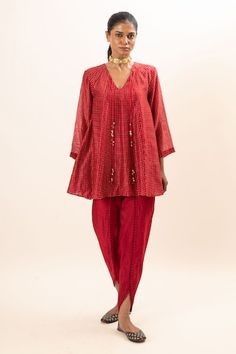 Red flared kurta with tie-up and tassel details. Paired with a dhoti pant with scalloped lace finish. - Aza Fashions Red Cotton Silk Sets For Navratri, Navratri Red Cotton Silk Sets, Red Cotton Silk Sets For Puja, Red Bandhani Print Kurta For Puja, Red Chanderi Set With Bandhani Print, Red Bandhani Print Blouse For Festive Occasions, Red Bandhani Print Blouse For Diwali, Festive Red Bandhani Print Blouse, Eid Bandhani Print Blouse For Puja