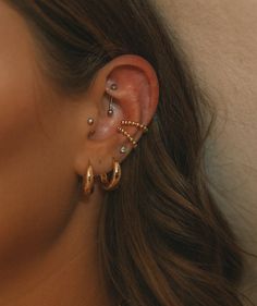 a close up of a person with ear piercings