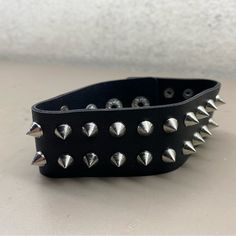 New Unisex Hot Topic Black Chrome Spiked Rocker Biker Bracelet One Size Edgy Black Spiked Choker, Punk Black Bracelet With Silver Studs, Adjustable Black Punk Wristband, Black Band Wristband For Concerts, Black Leather Punk Bracelet With Silver Studs, Edgy Silver Studs Jewelry, Adjustable Punk Bracelets For Biker Events, Punk Black Bracelets With Spikes, Black Punk Bracelets For Festival