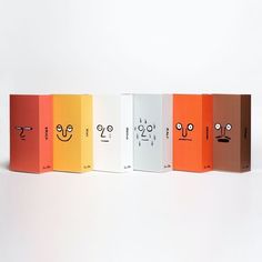 five colorful boxes with faces drawn on them