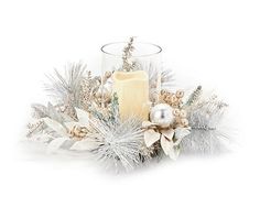 a candle and some silver decorations on a white background with snowflakes, pine cones and berries