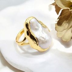 🌟 Elevate Your Elegance with Our Natural White Baroque Pearl Ring! 🌟 Indulge in the timeless beauty of our adjustable gold-plated ring, featuring a stunning white baroque pearl. This luxurious piece combines natural elegance with a touch of sophistication, perfect for the modern woman who appreciates classic style. ✨ Features: * Natural White Baroque Pearl: Each pearl is unique, adding to the charm of this elegant ring. * Adjustable Gold-Plated Band: Ensures a comfortable fit for any finger si Heirloom Baroque Jewelry For Weddings, Elegant Baroque Pearl Ring For Wedding, Elegant Baroque Pearl Wedding Ring, Elegant Gold Rings With Baroque Pearls, Exquisite Gold Wedding Rings, Gold Baroque Pearl Ring For Wedding, Elegant Gold Pearl Ring With Baroque Pearl, Elegant Gold Baroque Pearl Ring, Gold Baroque Pearl Ring