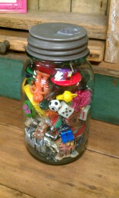 a jar filled with lots of different types of toys