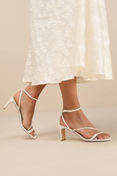 Keep things chic and simple by adding the Lulus Kierha White Satin Strappy Low Heel Sandals to any of your effortlessly elegant 'fits! Sleek woven satin shapes these darling heels that feature a square footbed and a trio of slender straps that cross the vamp. A matching strap wraps the front of the ankle and secures with a gold buckle, all atop a trendy blade heel. 2. 75" wrapped blade heel. Cushioned insole. Felted rubber sole has nonskid markings. Man made materials. Imported. Lulus | Kierha White Satin Strappy Low Heel Sandal Heels | Size 6.5. Low Heels Sandals, Strappy Wedding Heels, Elegant Fits, Bridesmaids Heels, White Strappy Heels, White Strappy Sandals, Prom 2024, Low Heel Sandals, Senior Prom