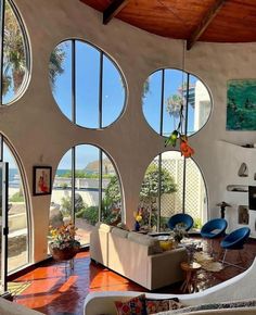 a living room filled with furniture and lots of windows