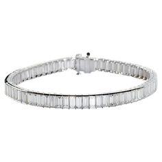 A modern baguette diamond bracelet, with 68, baguette-cut diamonds, with a total weight of 16.23 carats, in channel settings, with individually hinged links, with open sides and a box and tongue clasp, with a safety clasp, mounted in platinum. Baguette Tennis Bracelet, Baguette Bracelet, Platinum Bracelet, Bracelet Tennis, Baguette Cut Diamond, Baguette Cut, Baguette Diamond, Tennis Bracelet, Diamond Bracelet