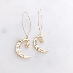 "DESCRIPTION: The AURORA Earrings - Gold crescent moons with Opal and CZ Stars. on a long gold filled ear wire. These celestial statement earrings will add the perfect bit of modern + minimalist vibes to your earring rotation! MATERIALS: Ear Wires - Gold Filled Moon and Star - Gold plated, Opal, CZ stones SIZE: Approximately 2\" in length MATCHING NECKLACE: https://etsy.me/2WOv4aj PACKAGING: Your earrings will arrive on a Dainty Doe signature jewelry card placed in a white jewelry box, with a bo Aurora Earrings, Friend Gifts Birthday, Star And Moon Earrings, Silver Jewelry Cleaner, Earrings Opal, Earrings Star, White Jewelry Box, Star And Moon, Crescent Moon Earrings