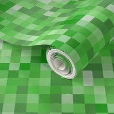 a green and white checkered wallpaper with a rolled up roll on it's side