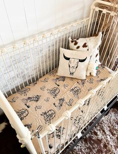 a baby crib with a pillow on top of it