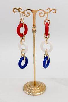 Make a statement with these unique Three Colorful Rings Earrings! Whether you want to add a pop of color to a simple outfit, or make a loud and proud fashion statement, these earrings are the perfect accessory. Add a touch of color and sparkle to your wardrobe!Details: Colorful Dangle Earrings Three Colorful Rings French Hook Ear Wire for Pierced Ears Approximate Dimensions: Length: 3.5" Rings: 0.75" DiameterRed, White and Blue ComboPink, Yellow and Purple Combo Trendy Red Circular Jewelry, Trendy Circular Earrings For Summer, Bold Multicolor Drop Earrings Jewelry, Trendy Circular Summer Earrings, Trendy Single Circle Earring, Bold Multicolor Drop Earrings, Trendy Circle Earrings With Ear Wire, Bold Jewelry With Matching Dangle Earrings, Trendy Circle Earrings