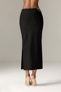 Our 'Star' midi skirt looks so chic paired with our 'Stella' top.It's luxuriously soft bandage in a slim, that hugs your curves in a classic and ultra flattering pencil silhouette, 'Star' has a comfortable flexible waistband that sits low on the natural waist and it has side zipper for easy wear and designed with an open curved side with dangling rhinestone chains for a daring flash of skin. WHERE TO WEAR: Stylish dinner dates, champagne bars, after work drinks, parties. TEAM YOURS WITH: Stella Sleek Party Midi Skirt, Sleek Midi Skirt, Sleek Evening Midi Pencil Skirt, Sleek Long Skirt For Night Out, Sleek Midi Pencil Skirt For Night Out, Sleek Pencil Skirt For Night Out, Modern Midi Skirt For Evening, Black Sleek Midi Pencil Skirt, Sleek Party Pencil Skirt With Lining