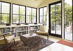 a living room filled with furniture and lots of windows