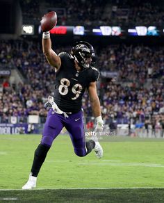 the baltimore ravens running back to his team after catching a football during a game against the new york jets