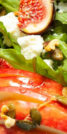 a close up of a salad with figs and cheese