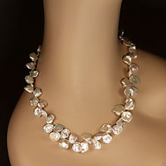 This is part of Chairish’s Fine Jewelry assortment.  Elegant 23-Inch Iridescent Keshi Pearl Necklace  This 23-inch necklace features exquisite white iridescent Keshi pearls, gently graduated in size from 9mm to 14mm. These uniquely shaped pearls, with their flat and rounded silhouettes, exude a luminous glow and captivating iridescence that effortlessly makes a statement.  Designed for both beauty and comfort, the necklace is secured with a versatile silver-plated toggle clasp featuring expandab Elegant Statement Necklace, Graduated Pearl Necklace, Japanese Pearls, White Pearl Jewelry, Keshi Pearl Necklace, Iridescent White, Iridescent Pearl, Kesha, Pearl Design