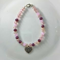 "🌸 Sign up for the Starfish by Kristan email list and get 15% off your order NOW! https://mailchi.mp/13833f6189a3/new-customers 🌸 Looking for high quality, affordable jewelry?  If so, this bracelet is for you!  This pink/clear 4mm round crystal bead bracelet with a silver heart charm. OUR BRACELETS ARE... *Made with high quality lava stones, semi-precious beads, silver, and glass beads *Tarnish free silver wire & gold wire, 925 silver, 1mm stretch cord, waxed linen cord *Crafted in house *Available in size 7.5\" CARE INSTRUCTIONS *Remove before swimming or showering *Do not use harsh chemicals  *Roll bracelet over hand, do not over stretch SHIPPING INFORMATION *Once I receive your order, I will ship out to you in the timeframe below *Orders are shipped in a padded mailer to ensure a safe Affordable Customized Pink Charm Bracelet, Bohemian Crystal Bracelet With Heart Beads, Pink Bohemian Jewelry For Valentine's Day, Bohemian Pink Jewelry For Valentine's Day, Pink Jewelry With Colorful Beads For Valentine's Day, Elegant Pink Beaded Bracelets With Heart Beads, Elegant Pink Heart Beaded Bracelets, Pink Valentine's Day Jewelry With Colorful Beads, Elegant Pink Heart-shaped Beaded Bracelets