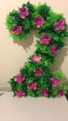 a number made out of green leaves and pink flowers