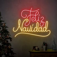 a neon sign that says feli's nabilad next to a christmas tree