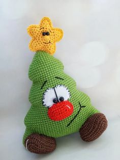 a crocheted christmas tree stuffed animal with a star on its head and nose