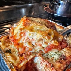 a pan filled with lasagna casserole sitting on top of a stove