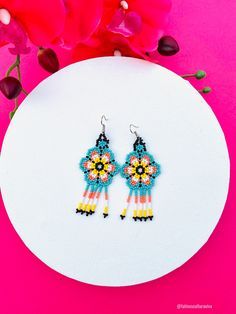 These beautiful Mexican earrings are so colorful and perfect for all-day wear. They are definitely the perfect accessory to style up your look and add personality to your outfit. These lovely handmade earrings are made with sterling silver hooks and colorful beads. The length of the beaded Earrings is approximate of 3 inches (8 cm) Each pair of earrings that we sell is authentic and one-of-a-kind! Thank you so much for visiting. If you have any questions, please do not hesitate to contact us. Jewelry Mexican, Hand Beaded Earrings, Huichol Earrings, Mexican Earrings, Huichol Art, Native American Beaded Earrings, Boho Style Earrings, Mexican Jewelry, Native American Beading