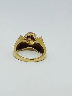 "This is a vintage 14K yellow gold, ruby, and diamond statement ring. The sharp edges of this ring give it a polished and refined look. Material(s): 14K yellow gold + (1) oval ruby + several diamonds Weight: 5.3 grams Flaws (if any): None to mention Marking(s): \"14K\" BAND SIZE 4 3/4 (or 4.75)" Heirloom Gold Ruby Ring With Diamonds, Vintage Yellow Gold Signet Ring With Center Stone, Classic Gold Ruby Ring Brilliant Cut, Antique Gold Ruby Ring With Diamonds, Classic Gold Ruby Ring With Brilliant Cut, Classic Gold Ruby Ring Collectible, Vintage Yellow Gold Diamond Signet Ring, Vintage 14k Gold Ruby Ring With Single Cut Diamonds, Vintage 14k Gold Ruby Ring With Diamonds