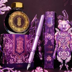 an assortment of beauty products displayed in front of purple and gold paper flowers on a black background