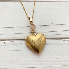 18 inches. Classic brass heart locket hand painted with Swarovski bead detail. Vintage Personalized Heart Charm Necklaces, Personalized Vintage Heart Charm Necklaces, Personalized Heart-shaped Vintage Charm Necklaces, Personalized Heart-shaped Vintage Charm Necklace, Adjustable Heart-shaped Engraved Necklaces, Personalized Adjustable Heart Pendant Locket Necklace, Handmade Gold Locket Necklace For Keepsake, Heart-shaped Brass Necklaces For Valentine's Day, Adjustable Gold Locket Charm Necklaces