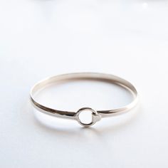 Friendship Bangle  The Circle Bangle is both simple and stylish. Slightly fitted it has a clasp to the side with tension from the band keeping it securely on the wrist. The width, when closed is 6.6 cms, the depth is 5.5 cms. The Sterling Silver band measures approx. 5mm x 2mm and is hallmarked 925. A beautiful piece that's great for stacking, but perfect on its own, making it a special addition to your collection or a wonderful gift for a special someone else. Treat yourself, or a special someone else, the bracelet comes in a satin-lined velvet jewellery travel pouch to keep your jewellery safe, wherever your next adventure lies, also perfect for gifting. Processing time is one to two days. I will send your parcel using Royal Mail, this is an economy standard service. If you would like yo Stackable Bangles, Circle Bracelet, Jewelry Safe, Sterling Silver Bangle, Bridesmaid Bracelet, Sterling Silver Bangles, Silver Bangle, The Circle, Travel Jewelry