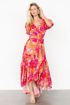 Make a statement in the colorful Lori Maxi Dress, featuring a vivid orange and pink floral print. This dress includes fun features like a high-low tulip skirt, ruffle detail, and short puff sleeves. Vibrant V-neck Maxi Dress For Spring, Spring Floral Print Rayon Maxi Dress, Floral Print Rayon Maxi Dress For Spring, Spring Tropical Print Maxi Dress With Short Sleeves, Spring Pink Maxi Dress With Vibrant Print, Vibrant Short Sleeve Maxi Dress With Floral Print, Spring Maxi Dress With Tropical Print And Short Sleeves, Vibrant Printed Midi Dress For Spring, Spring Maxi Dress With Vibrant Print For Day Out