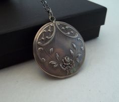 Vintage French Art Nouveau Locket w/Original Photos -- Beautiful reliquary locket with original photos intact, dated to the Art Nouveau/Deco period, excellent condition. Can be paired with a new 24" black stainless steel chain. Rare and gorgeous memorial heirloom locket. Exceptional and unique repousse detail.  Ships boxed through Etsy labels with tracking to USA - thanks and happy shopping! Engraved Locket Necklace With Round Pendant, Collectible Round Necklace With Intricate Design, Unique Stamped Jewelry For Formal Occasions, Antique Silver Jewelry As A Gift, Antique Silver Jewelry Gift, Antique Silver Heirloom Jewelry, Heirloom Antique Silver Collectible Jewelry, Unique Medallion Necklace For Wedding, Antique Locket Pendant Necklace With Intricate Design