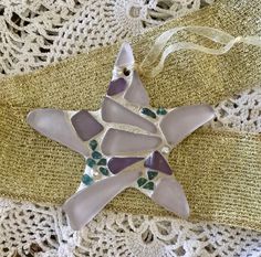 a glass star ornament sitting on top of a doily