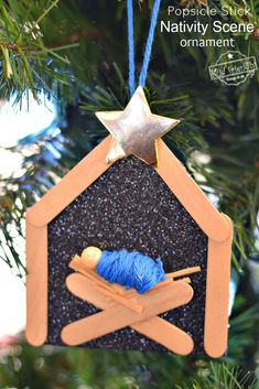 an ornament hanging from a christmas tree with knitting needles and yarn in it