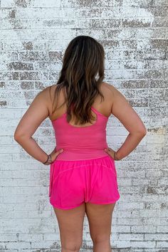 This Athletic Cut Out Romper in Pink offers a winning combination of style and comfort. It's made from a soft blend of nylon and spandex, so you can be agile without sacrificing on fashion. Perfect for casual days and athleisure, the criss cross straps and small cut-out under the chest make sure you're turning heads - in all the right ways. Get fit in style! Model is wearing a size medium. Stocked at Arlington Village and Uptown. Pink Nylon Activewear With Go-dry Technology, Casual Compression Tank Top With Built-in Bra, Spring Workout Activewear With Built-in Bra, Spring Sports Tank Top With Built-in Bra, Summer Activewear With Built-in Bra And High Stretch, Spring Fitted Activewear With Mesh Back, Fitted Activewear With Mesh Back For Spring, Summer Racerback High-stretch Activewear, Stretch Nylon Tank Top With Mesh Back