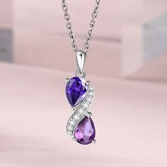 Step into a world of enchantment with this stunning necklace, adorned with two lustrous pear-cut purple stones, each exuding its unique shade and allure. Nestled between them, a radiant swirl of glistening white stones adds a touch of celestial brilliance, creating a harmonious dance of colors and light. Embrace the beauty of contrast and sophistication, let this exquisite piece be a symbol of your elegance and charm, a timeless treasure that captures the essence of grace and luxury.Carat Weight White Stones, Magical Jewelry, Round Necklace, Amethyst Purple, Purple Stones, Necklace Online, Stunning Necklace, Timeless Treasures, Pear Cut