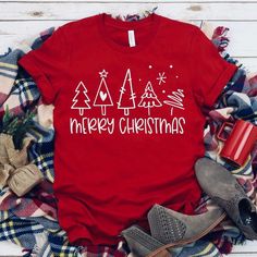 S 4 M 6 L 8/10 Xl 12 Merry Christmas Multi Tree Screen Print Tee. Pictured On Red. Soft Tee. Material Is Cotton And Polyester Christmas Cotton T-shirt, Red Short Sleeve Tops For Winter, Red Crew Neck Christmas Top, Red Crew Neck Top For Christmas, Red Graphic Print T-shirt For New Year, Red Crew Neck Top For Gift, Red Crew Neck Holiday Top, Red Crew Neck Top For Holiday, Red Holiday Crew Neck T-shirt