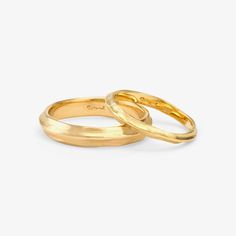 two yellow gold wedding rings on a white background, one is plain and the other is plain