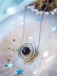 If you like astronomy, galaxies and outer space, this spinning necklace is the perfect accessory for you. This beautiful piece is made with 3 silver-plated brass rings, elegantly placed one inside the other to create a pendant inspired by the planetary galactic orbits. The inner piece is Natural Lava Stone Bead and imitates the texture and shape of an asteroid. ✦ You can spin the necklace! It's truly satisfying and entertaining to spin while you're wearing it! It's almost anti-stress! Such a del Space Themed Jewelry, Space-themed Pendant Jewelry Gift, Galaxy Pendant Necklace, Astronomy Necklace, Spinning Necklace, Astronomy Jewelry, Space Necklace, Galaxy Necklace, Astronomy Gift