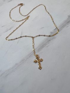 Elevate your style with our Crucifix necklace, featuring a delicate sequin chain perfect for layering. Express your faith with elegance in a subtle yet powerful way. 14K Chain is 18" long with a 2" drop Dainty Crucifix Necklace With Adjustable Chain, Dainty Crucifix Cross Necklace With Delicate Chain, Dainty 14k Gold Cross Necklace With Delicate Chain, 14k Gold Filled Cross Necklace With Delicate Chain, Dainty Gold Chain Lariat Necklace, Dainty Lariat Necklace With Gold Chain, Dainty Gold Lariat Necklace, Cross Necklace Aesthetic, Chunky Cross Necklace