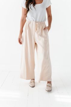 Features High Rise Wide Leg Side Pockets Zipper Closure Elastic waist with waist tie Lined from waist to thigh Cream color Self: 100% Polyester; Lining 100% Polyester Size + Fit Kristin is 5'4", a size 1 and is wearing a Small Jacquelyn is 5'4" and is wearing a size 25 Small 2-4, Medium 6-8, Large 10-12, X-Large 14-16 True to size. Do have stretch, but do not lose shape. Waist measurements are taken while laying flat and doubled. Click here for top Click here for shoes Size Waist Rise Inseam Sma Day Out Paperbag Waist Bottoms With Tie Waist, Spring High Waist Belted Wide Leg Pants, Belted Wide-leg Pants For Spring, Spring Wide-leg Belted Bottoms, Relaxed Fit Paperbag Waist Bottoms With Pockets, Relaxed Fit Paperbag Waist Workwear Pants, Relaxed Fit Paperbag Waist Pants For Work, Belted Beige Trousers, Belted High-waisted Pants For Spring