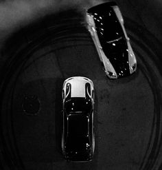 two cars are seen from above in black and white