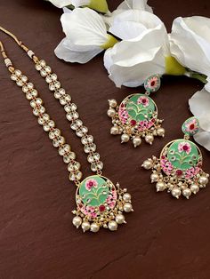 Gorgeous gold plated. Beautiful and elegant Kundan and Meenakari Necklace Perfect for Indian weddings. Size- Adjustable Premium Quality and High craftsmanship Gorgeous 24 K gold plated. All the raw material used in this product is of high quality and is handcrafted with love. Premium Quality and High craftsmanship 100% Satisfaction Guarantee: Long Lasting Plating, High-Quality Stones. Gifting: This pair of charming necklace and earrings come in a beautiful gift box, making it an ideal gift for b Temple Jewelry Bridal Necklace With Gota Work, Traditional Kundan Necklace With Gota Work As Gift, Temple Jewelry Necklace With Gota Work As Gift, Temple Jewelry Necklace With Gota Work, Bollywood Style Temple Necklace With Gota Work As Gift, Bollywood Style Temple Necklace With Gota Work, Kundan Meenakari Necklace Gift, Festive Kundan Necklace With Meenakari, Festive Round Kundan Necklace With Meenakari