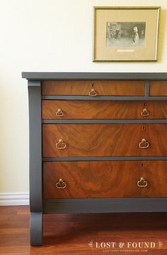 a wooden dresser with four drawers and two pictures on the wall above it, along with a wood floor