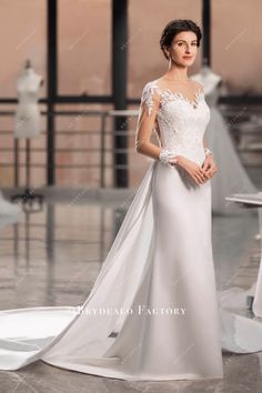 a woman in a white wedding dress posing for the camera